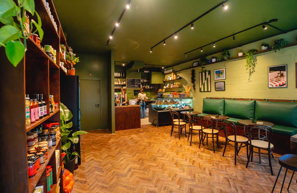 Herringbone floor in a busy Ancoats deli with green walls