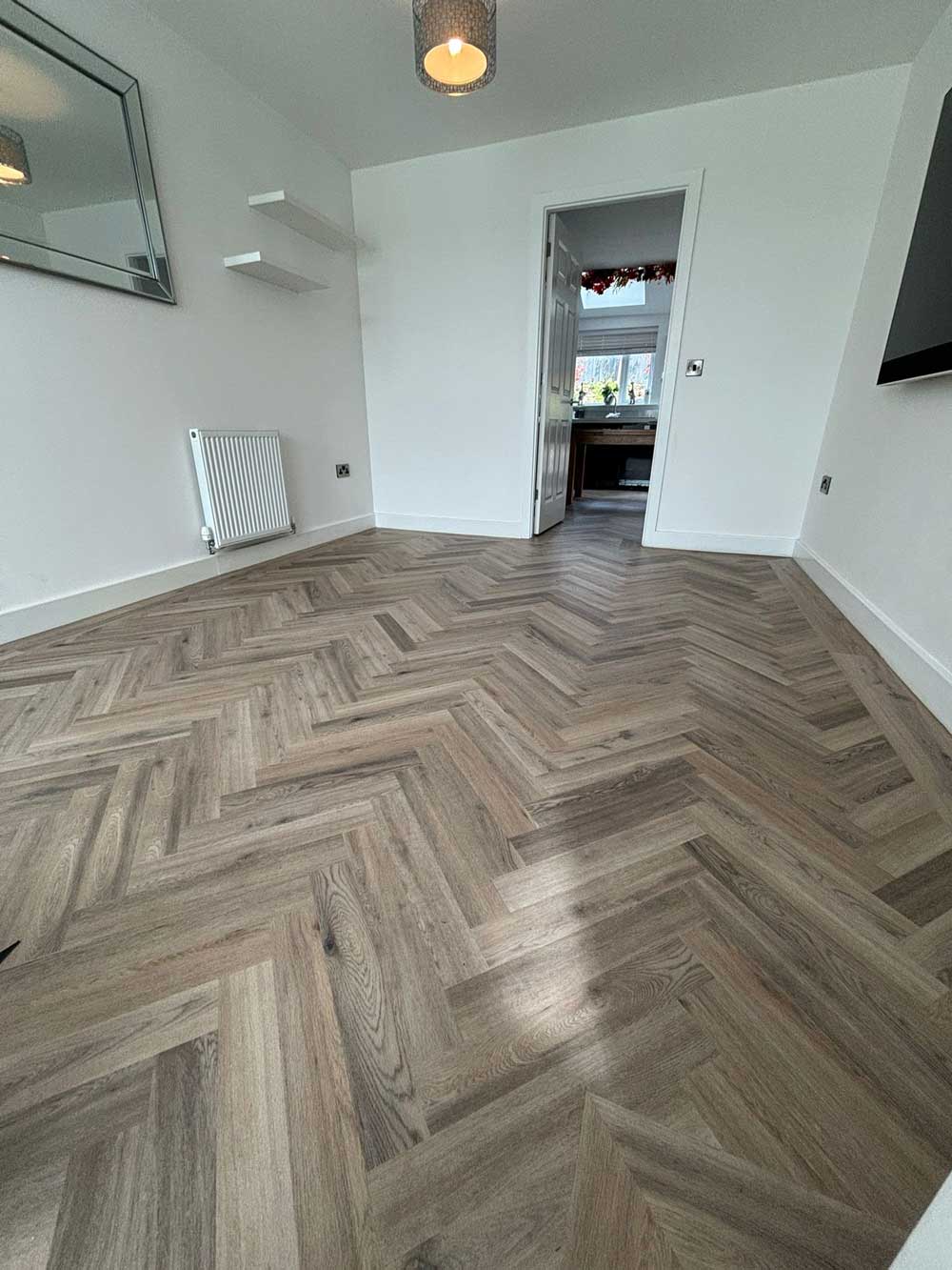 Grey herringbone LVT in an open-plan home