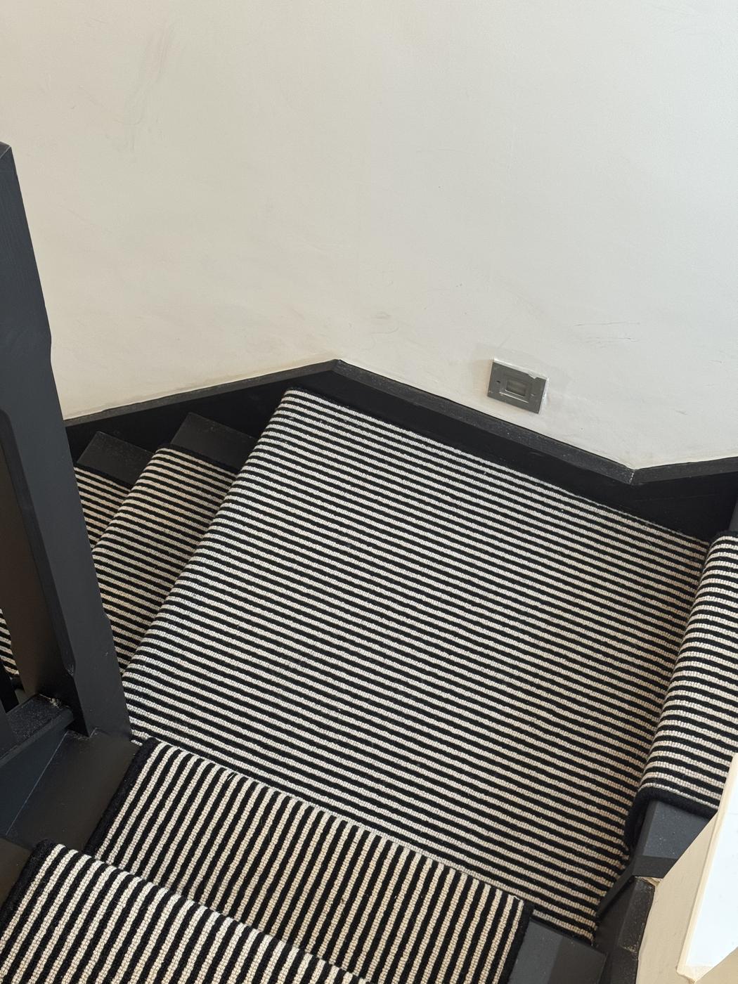 Striped stair runner fitted with brass rods